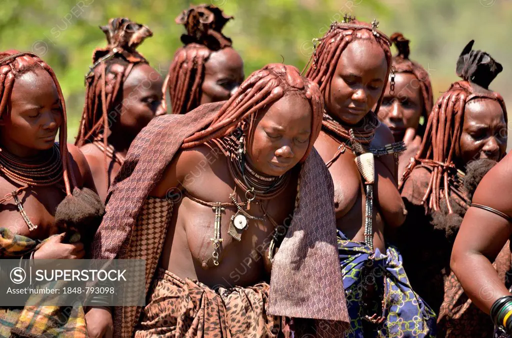 Mourning Himba women at a funeral, the widow in the middle