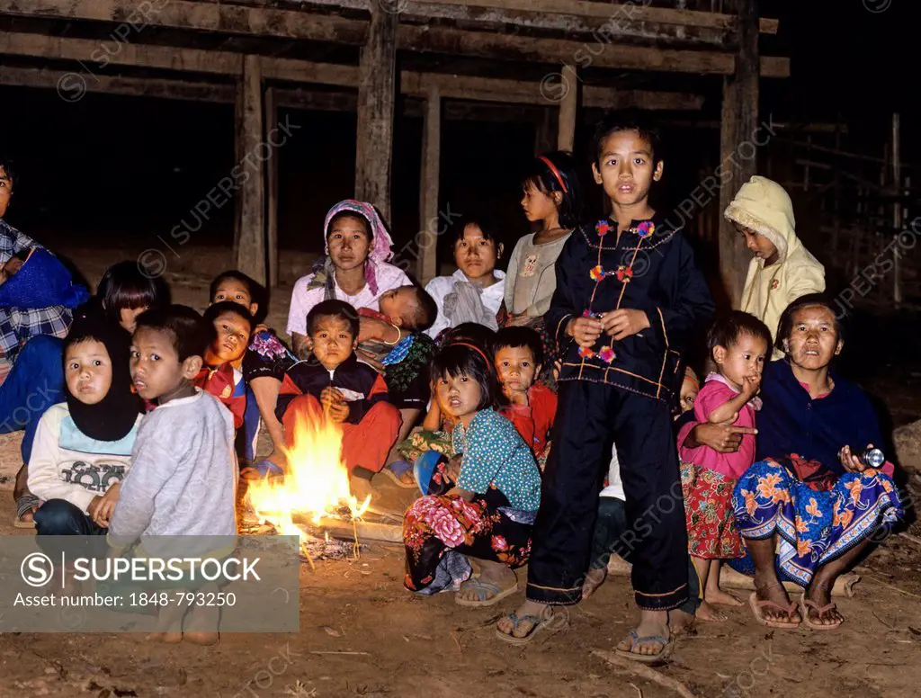 Lahu children sitting around a campfire in a mountain village, harvest festival
