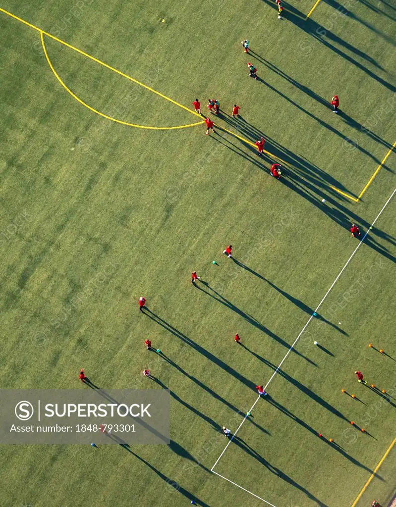 Aerial view, training on the football pitch of the Hammer Spielvereinigung SpVg sports association, players cast long shadows