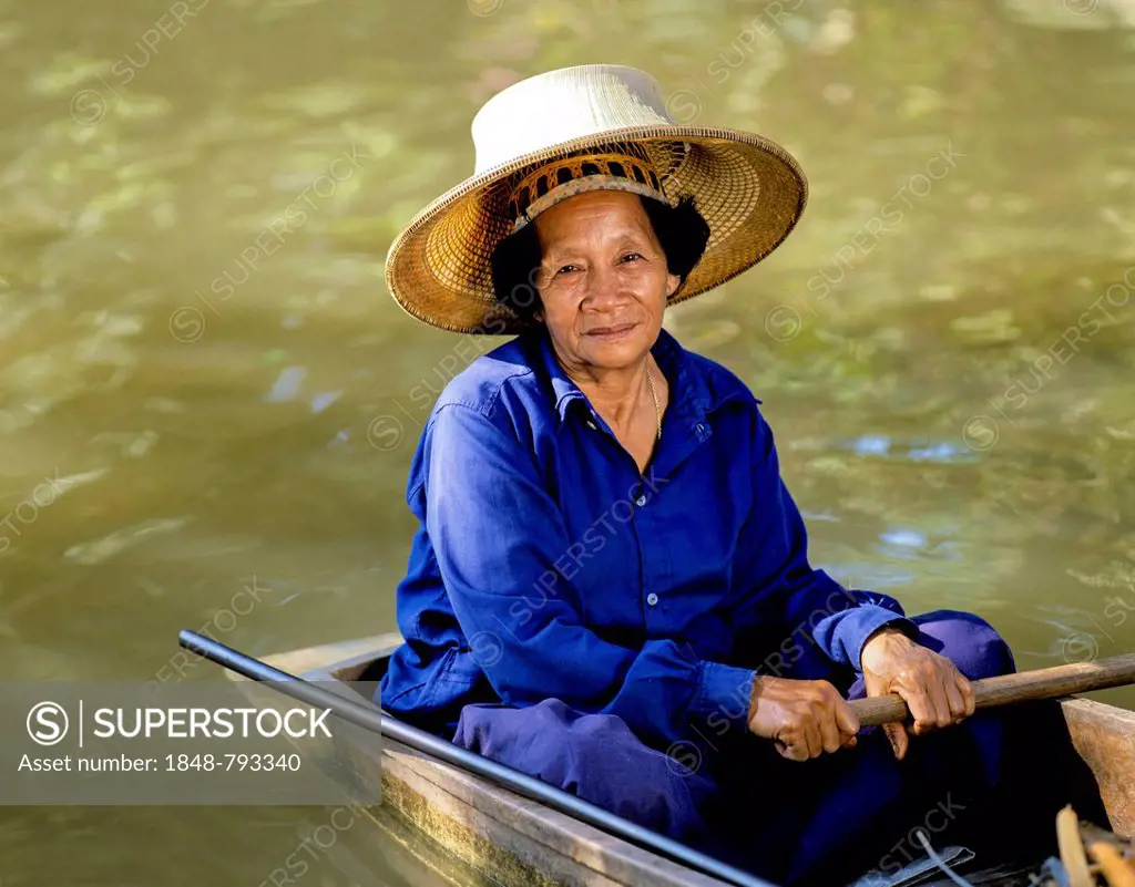 Elderly woman on a boat, floating market