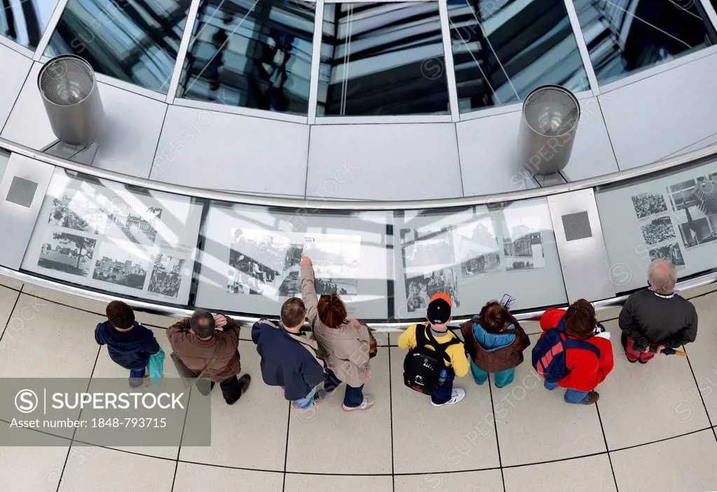 Visitors viewing an exhibition in the interior of the dome of the Reichstag Building, German Bundestag, architect Sir Norman Foster