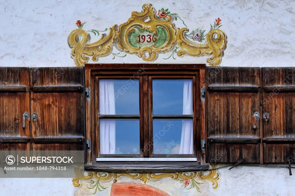 Window with shutters and Lueftlmalerei murals from 1936 on a farmhouse