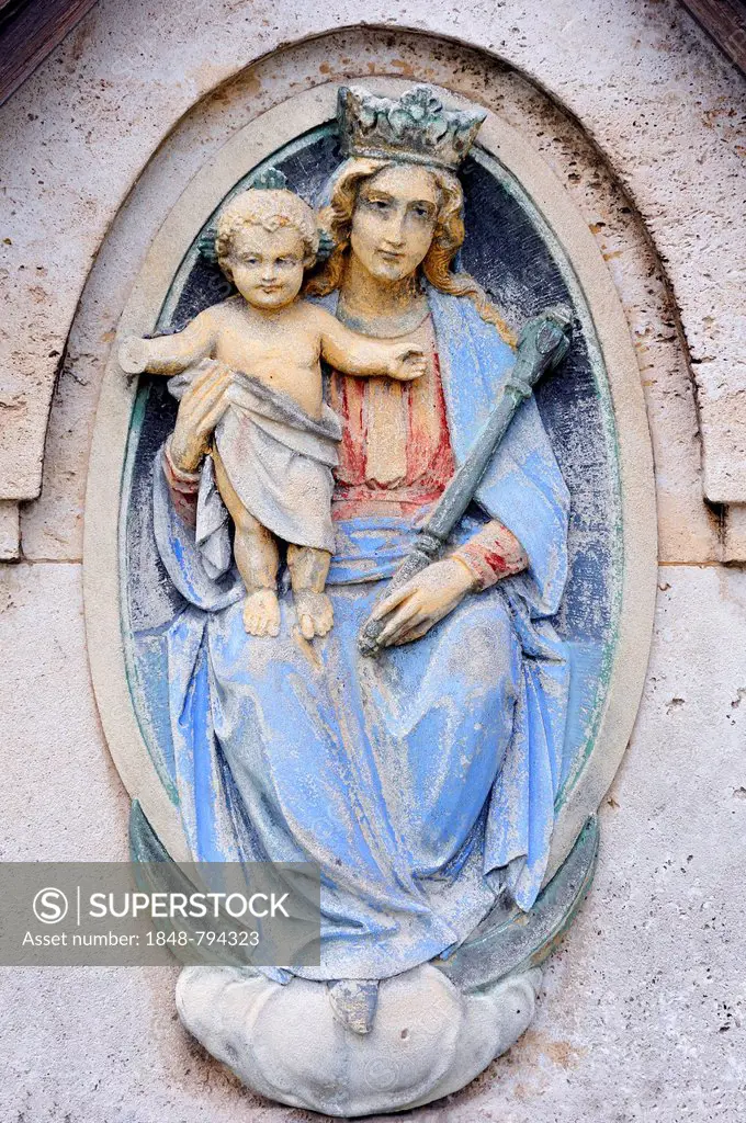 Relief, representation of St Mary with the baby Jesus on a grave in a cemetery