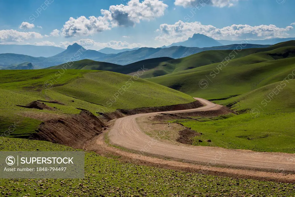 Road sneaking through the green hilly landscape, on the border of Iran