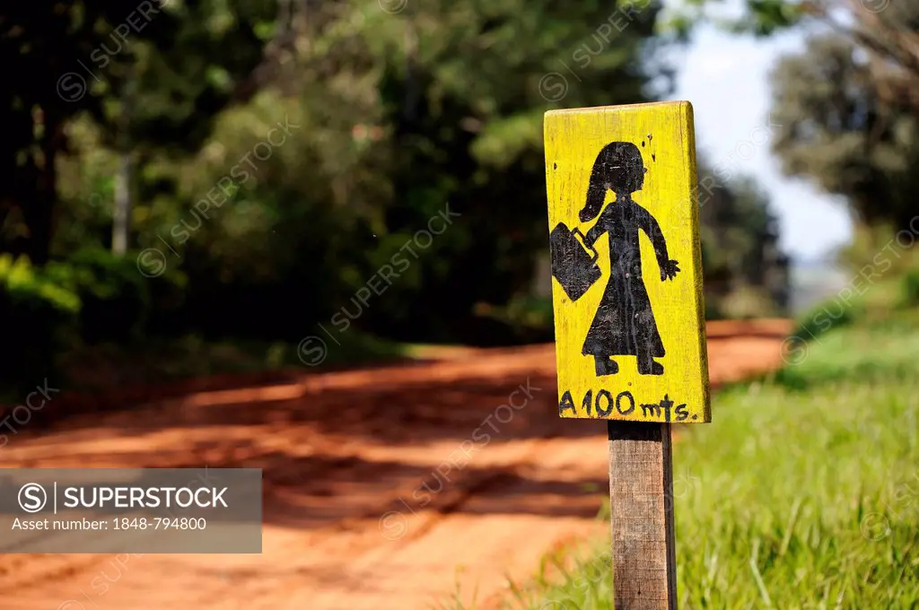 Hand painted wooden sign Caution, schoolchildren in a Mennonite community
