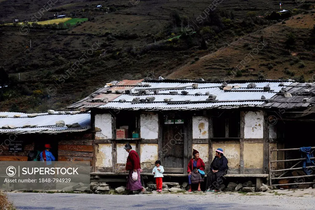 Small shop on the roadside with people out the front
