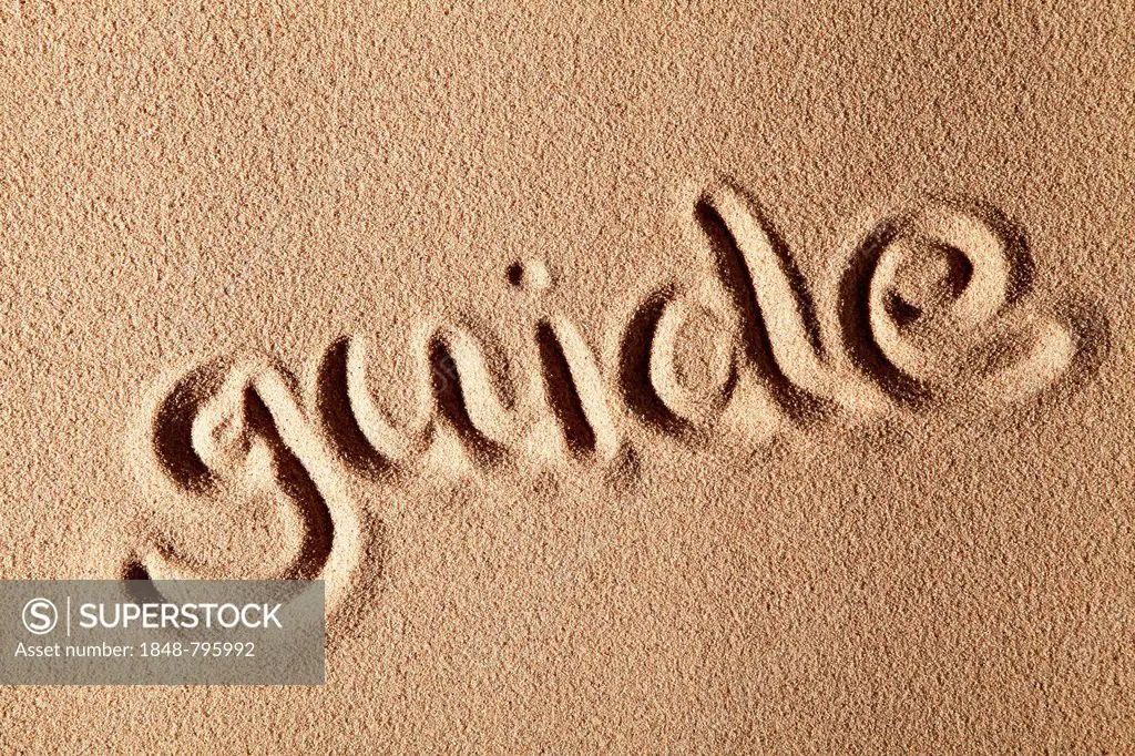 The word guide, written in sand