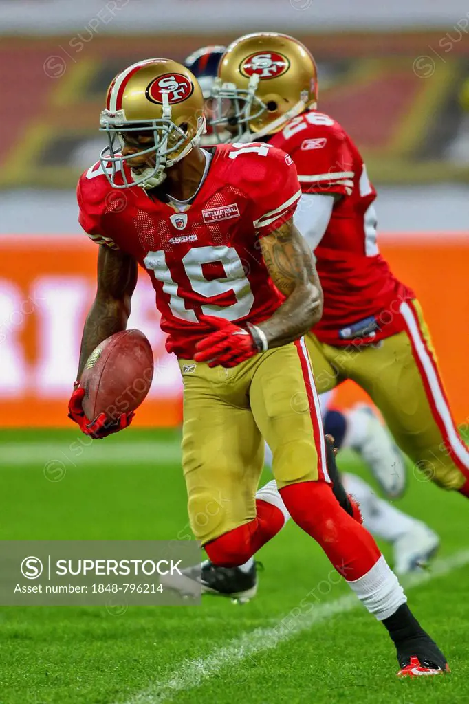 WR Ted Ginn, #19 49ers, runs with the ball during the NFL International game between the San Francisco 49ers and the Denver Broncos on October 31, 201...