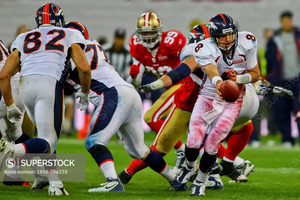 QB Kyle Orton, #08 Broncos, hands off the ball during the NFL International game between the San Francisco 49ers and the Denver Broncos on October 31,...