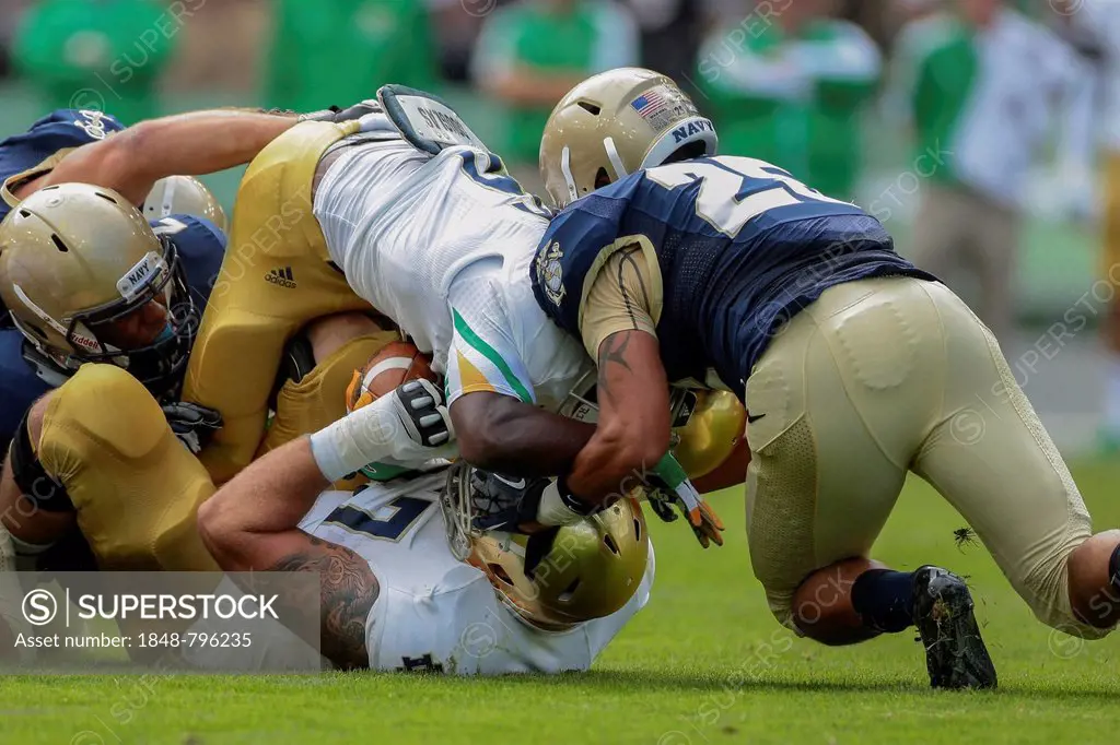 RB Theo Riddick, #6 Notre Dame, is tackled during the NCAA football game between the Navy and the Notre Dame on September 1, 2012 in Dublin, Ireland, ...