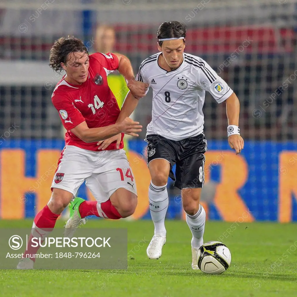 Mesut Oezil, #8 Germany, and Julian Baumgartlinger, 14 Austria, fight for the ball during the WC qualifier soccer game on September 11, 2012 in Vienna...