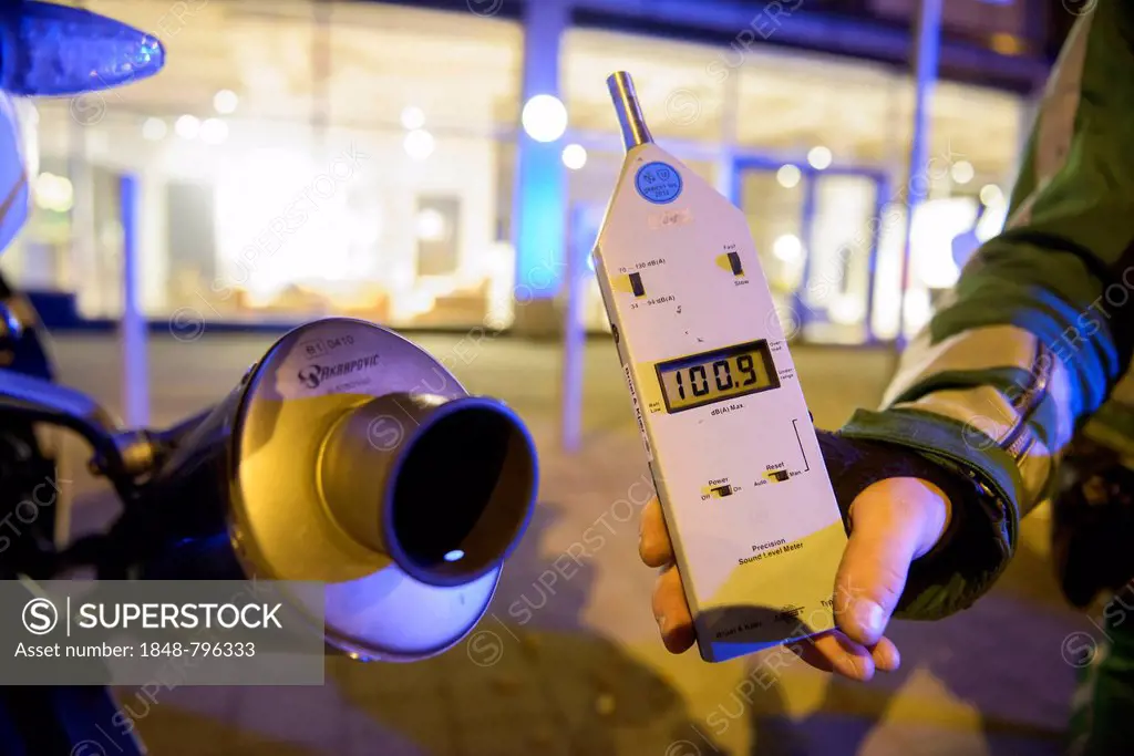 Police control, policeman holding a noise level meter beside the exhaust of a motorcycle whose noise reduction device has been removed, Theodor-Heuss-...