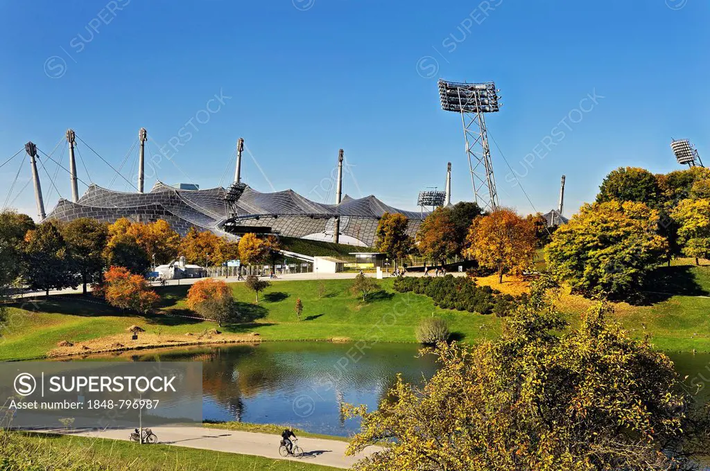 Pavilion-roof of the Olympic Hall, floodlights and lake Olympiasee, Munich, Bavaria, Germany, Europe
