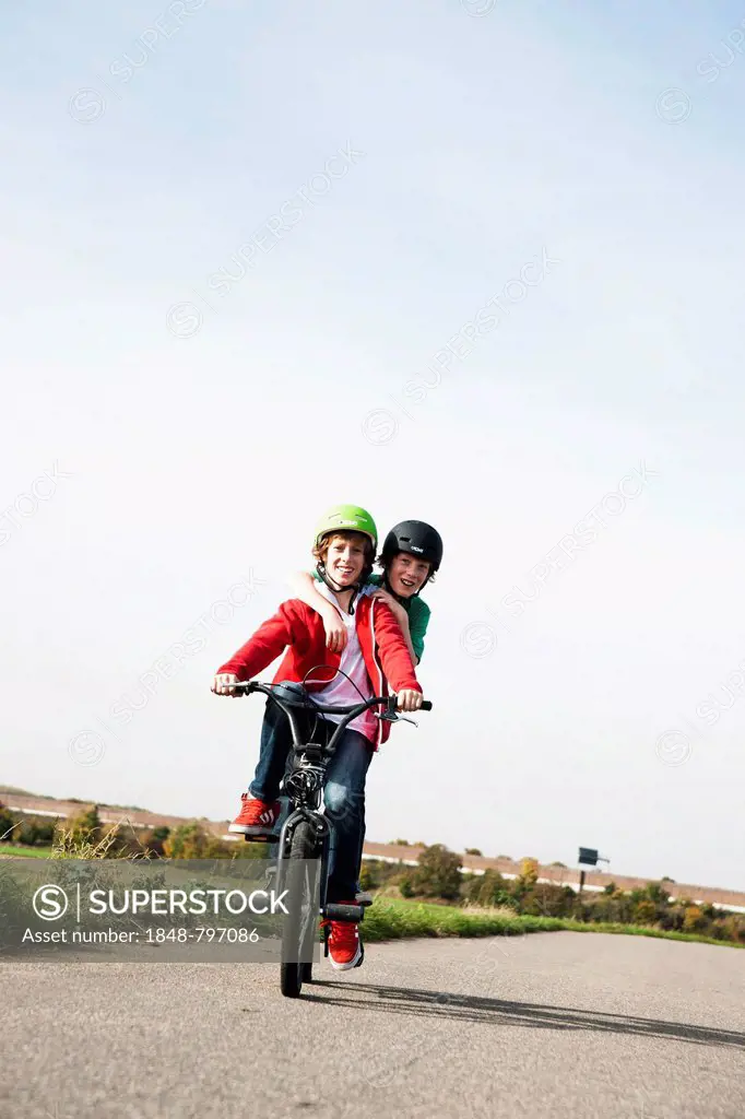 Two cool boys on a BMX bike