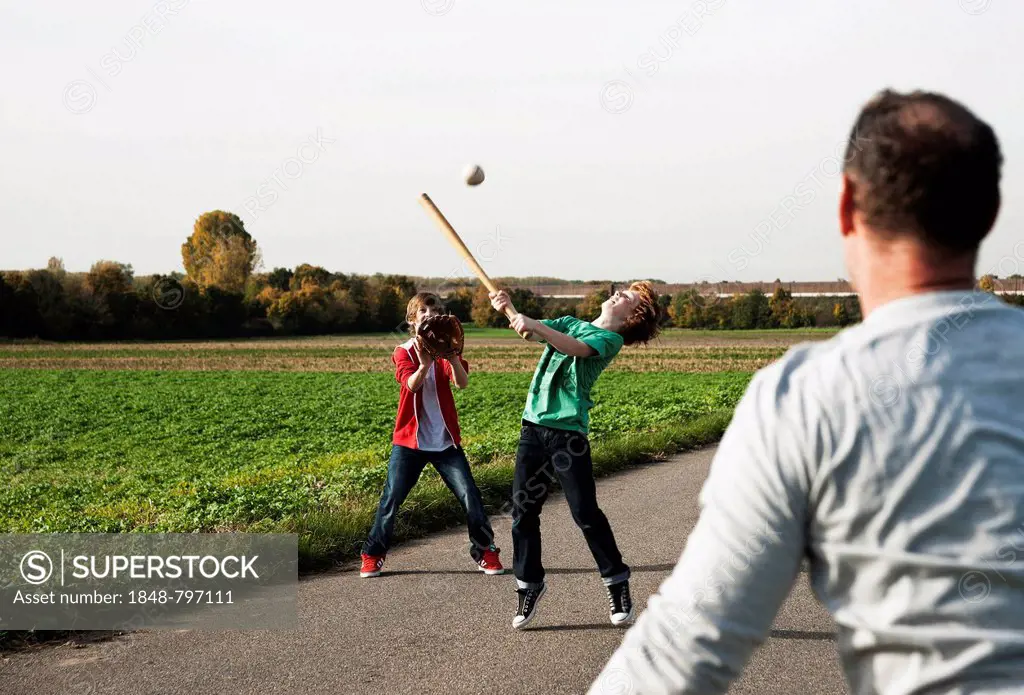 Father playing baseball with his sons
