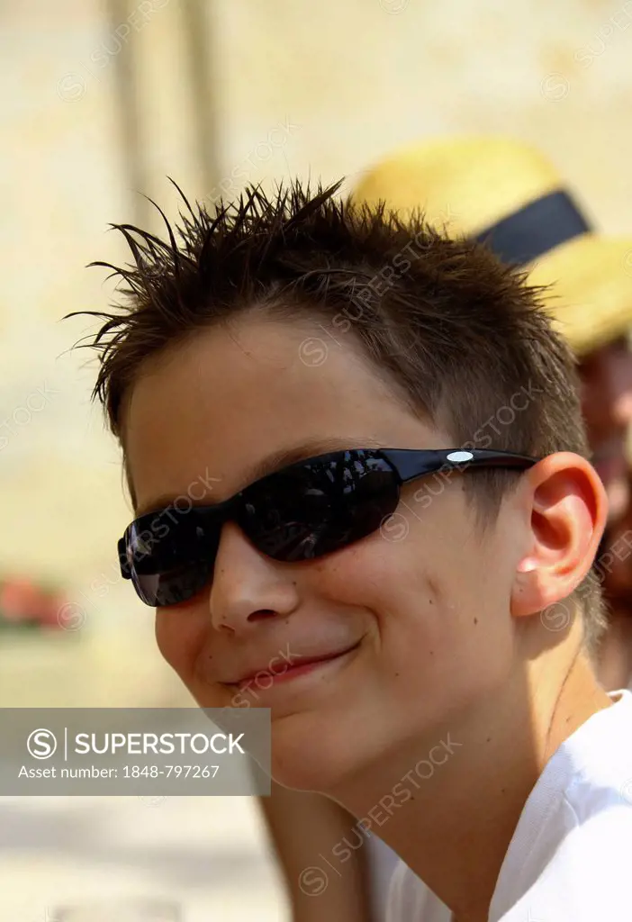 Boy, 12, wearing sunglasses, with gel in his hair, portrait