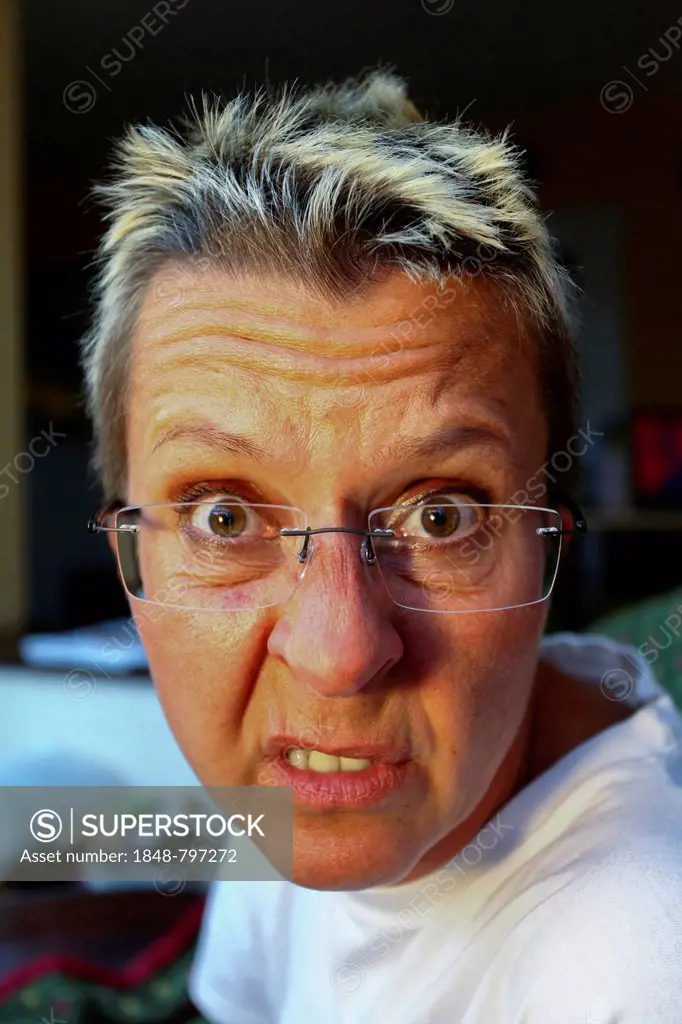 Woman with glasses making a grimace