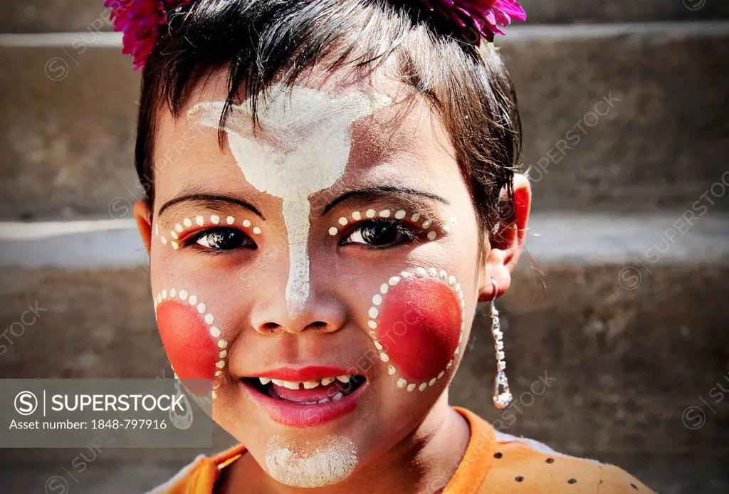 Smiling girl with thanaka paste on her face in Mandalay, Myanmar, Burma, Southeast Asia, Asia