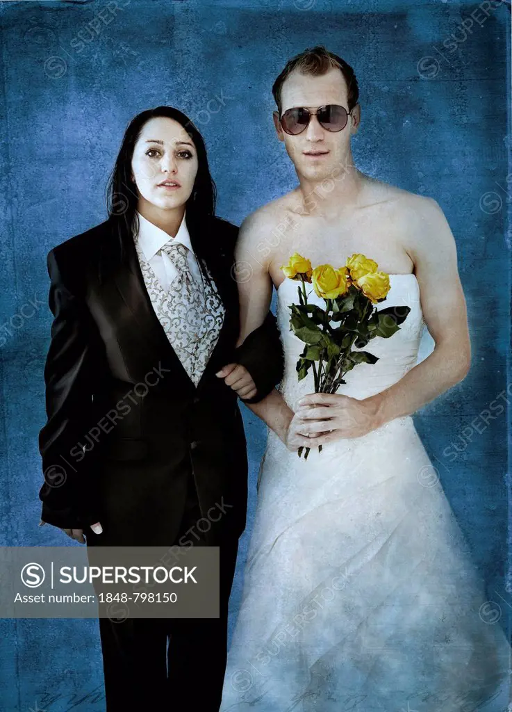 Bride wearing a suit and a groom wearing a wedding dress with sunglasses and yellow roses