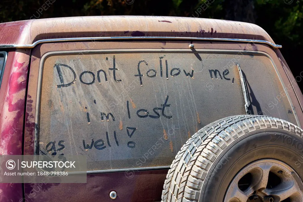 Don't follow me, i'm lost as well, written on dust covered car window