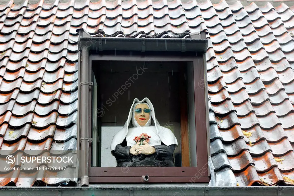 Caricature of a nun in a window