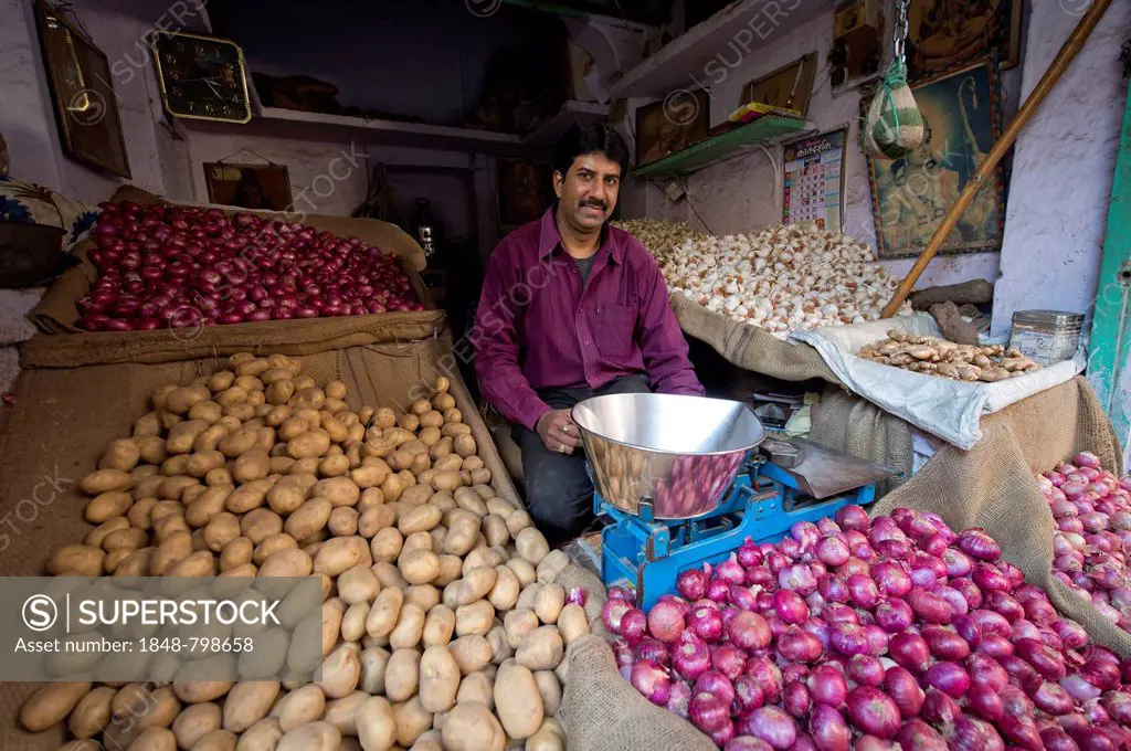 Potato and onion trader at his market stand