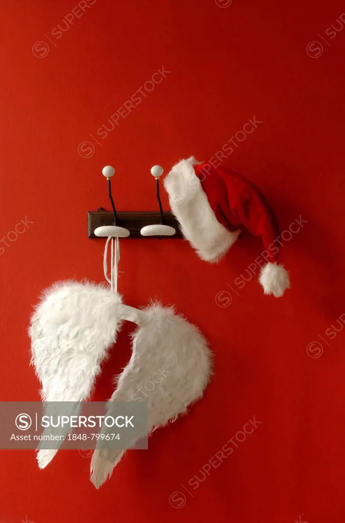 Santa hat and angel wings hanging on nostalgic coat hooks