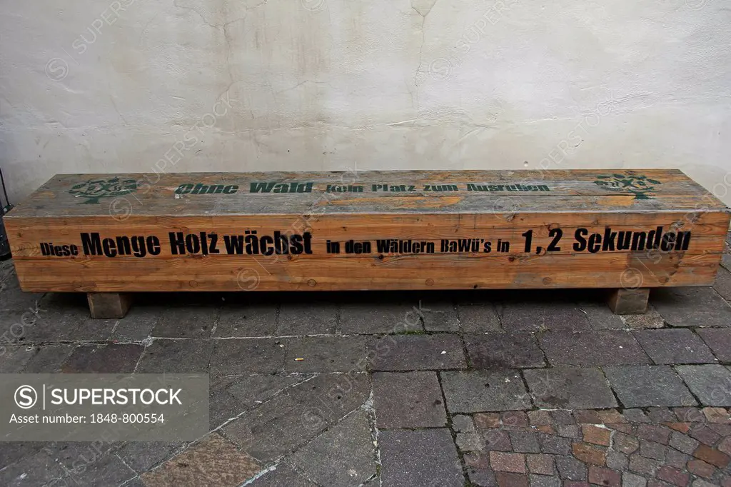 Wooden bench with a note Ohne Wald kein Platz zum Ausruhen, English for without forests, there is no place to rest, eye-catching artwork, in Kirchplat...