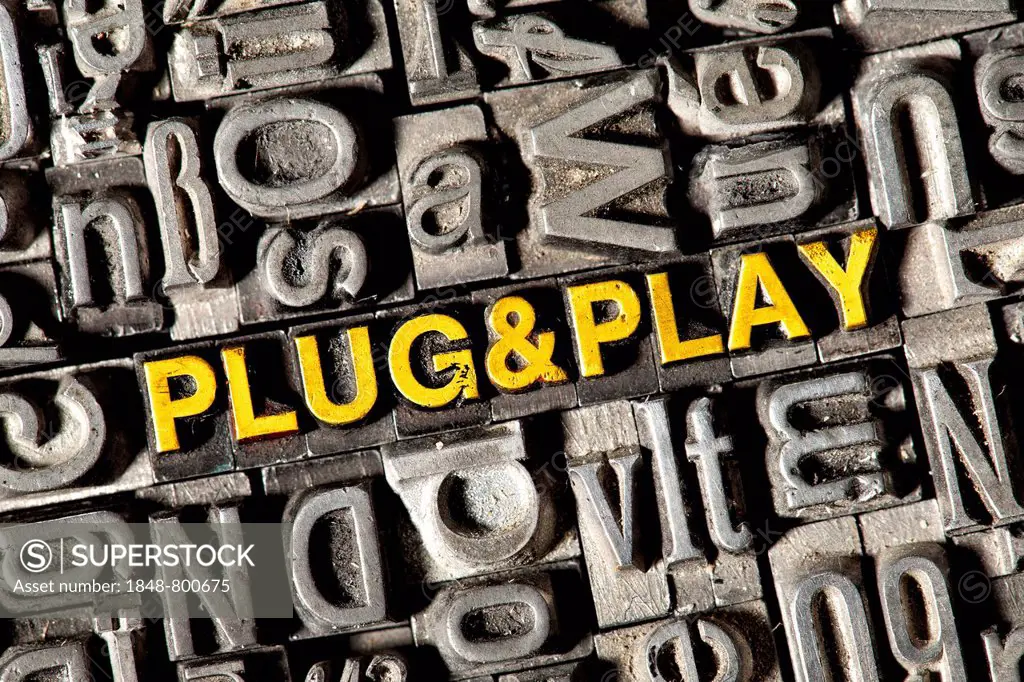 Old lead letters forming the words Plug and Play