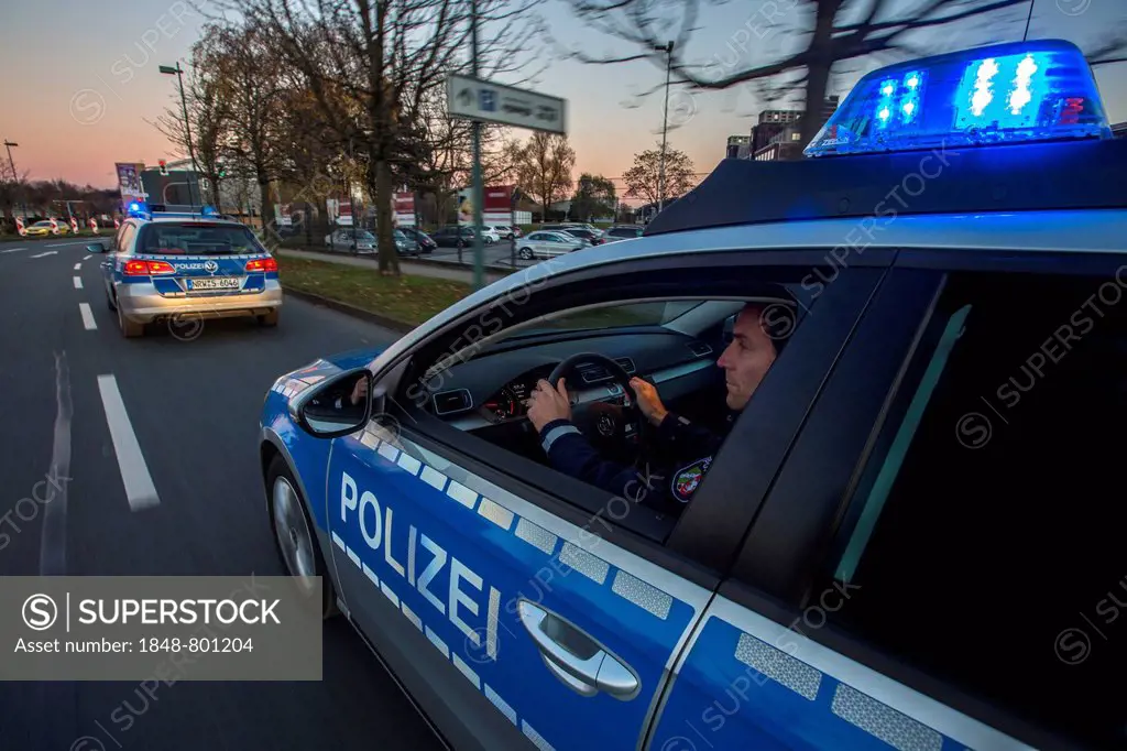 Police patrol car in an emergency operation, with blue lights and sirens, Germany, Europe
