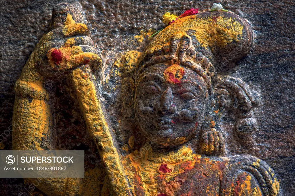 Guardian figure with a sword, decorated with red and yellow kumkum powder, Meenakshi Amman Temple or Sri Meenakshi Sundareswarar Temple, Madurai, Tami...