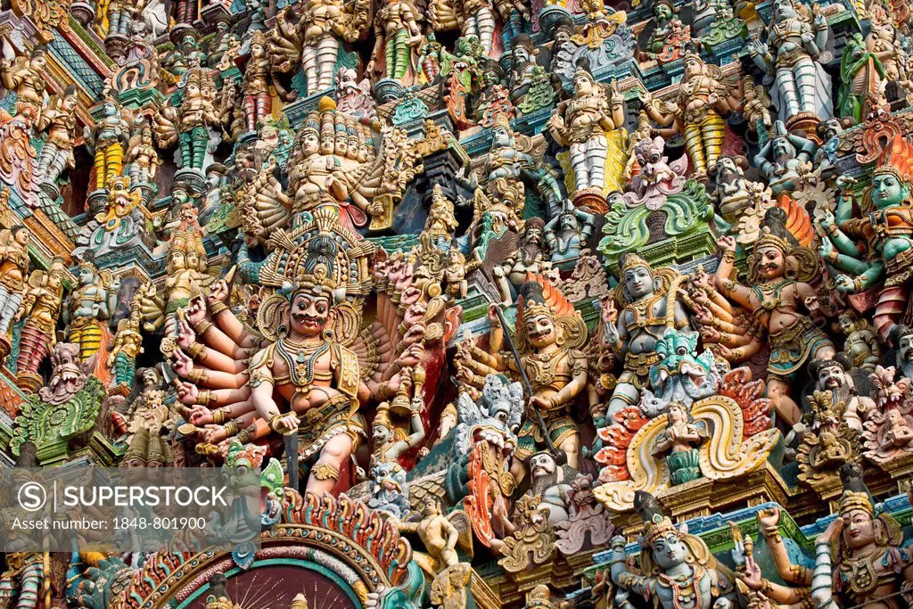 Colourful statues of gods and demons on the Gopuram or Gopura gate tower, Meenakshi Amman Temple or Sri Meenakshi Sundareswarar Temple, Madurai, Tamil...