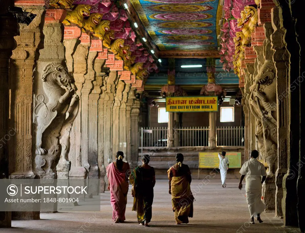 Visitors in the temple hall with brightly painted pillars, mythical creatures, Meenakshi Amman Temple or Sri Meenakshi Sundareswarar Temple, Madurai, ...