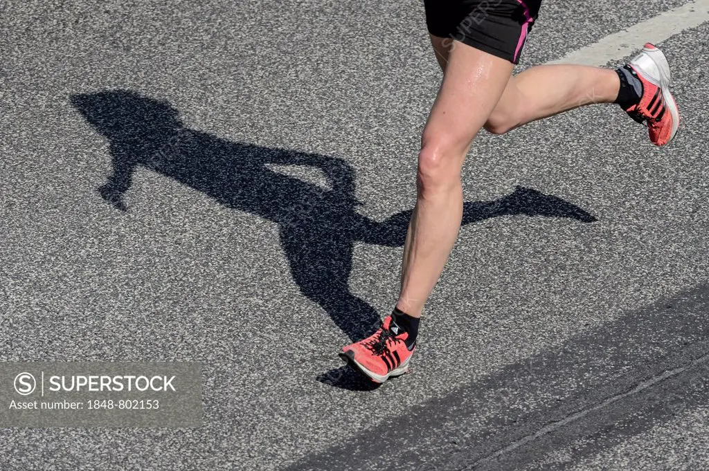 Legs and shadow of a marathon runner, Hamburg, Germany