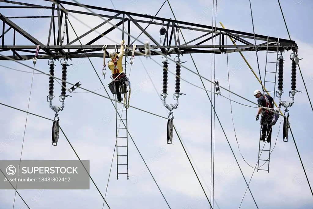 High-voltage service technicians installing a new high voltage power line, Wiesing, Schwaz District, North Tirol, Tirol, Austria