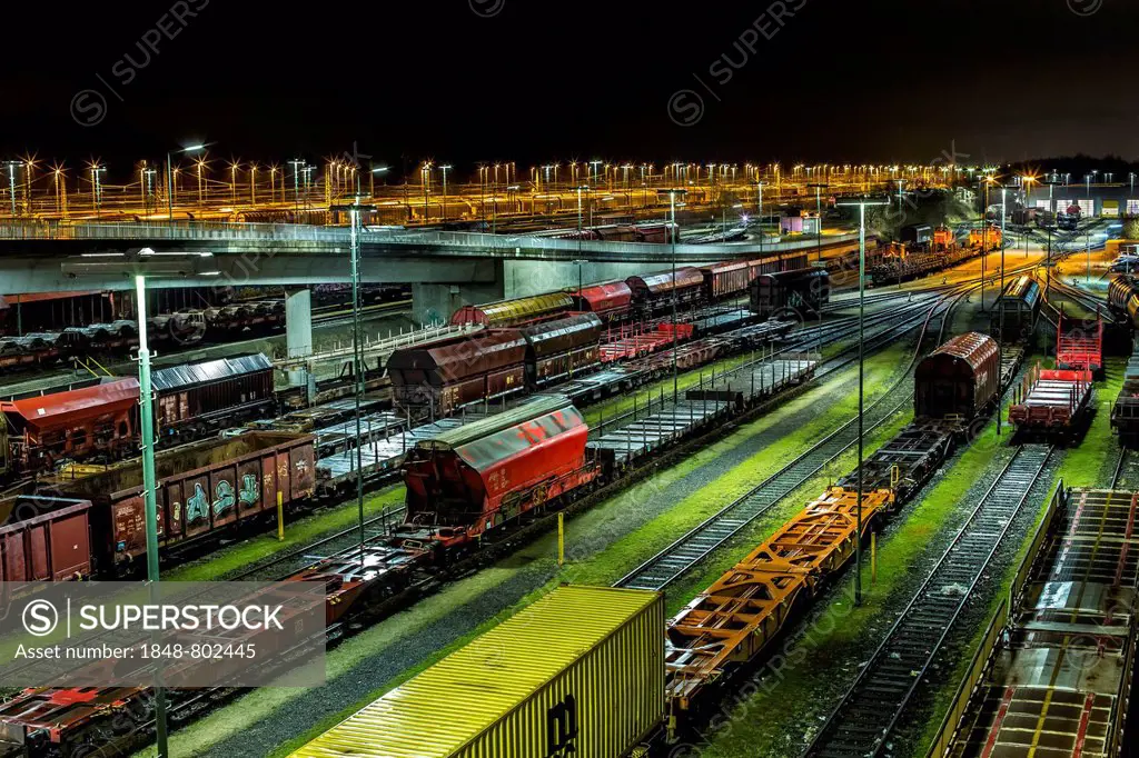 Parked goods wagons on the tracks of the Maschen marshalling yard at night, Maschen, Lower Saxony, Germany