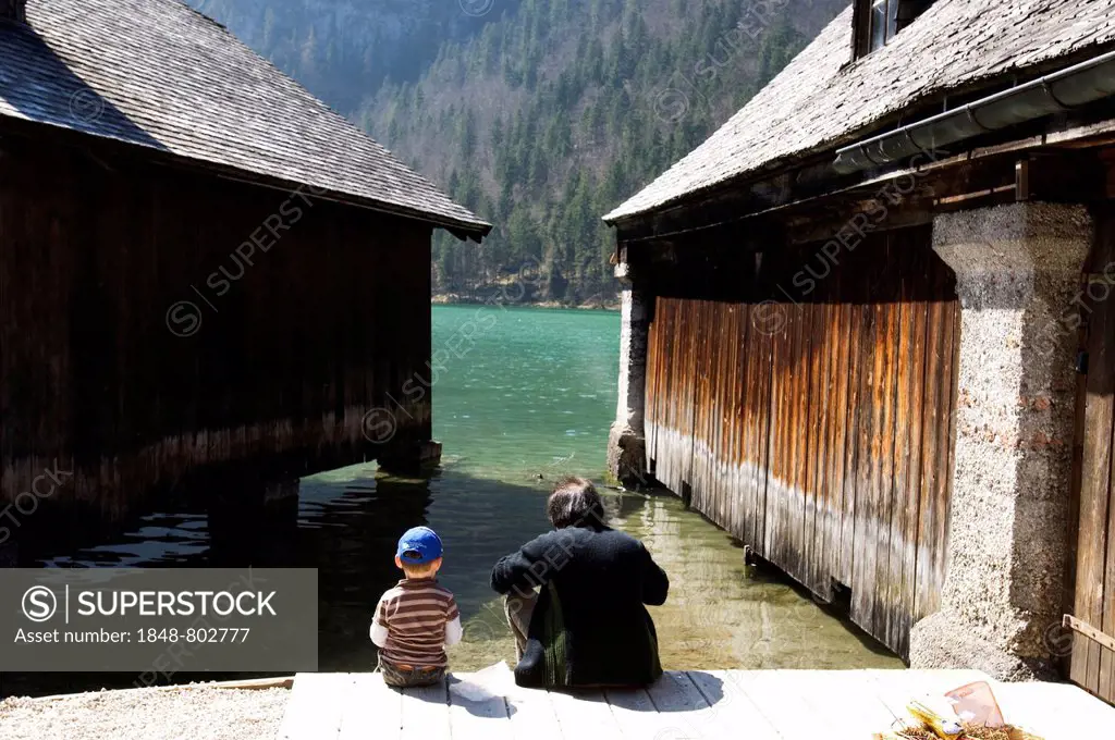 Father and son, near two boathouses in Koenigssee, Bavaria, Germany