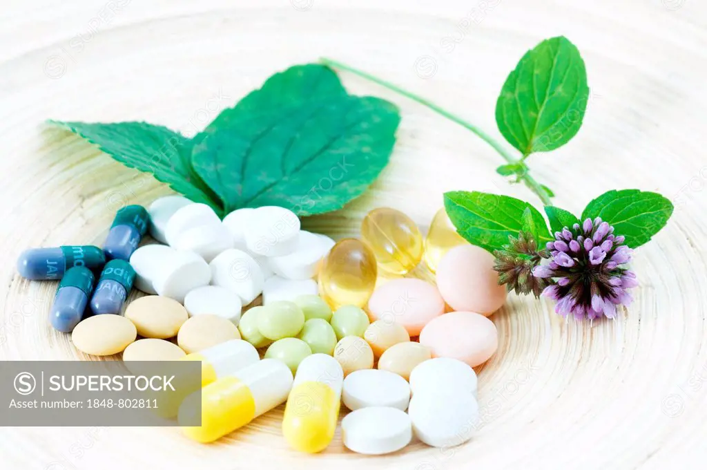 Vegetable cures, Phytopharmaka. Medicines, pills, tablets and caps lie beside sheets of mint