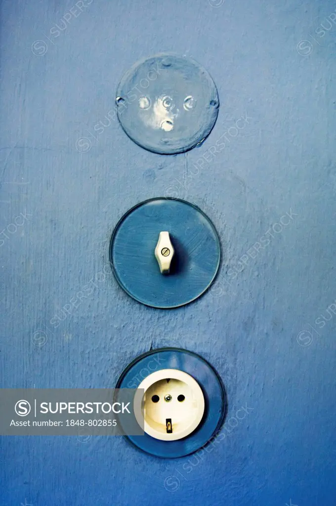 Light switches and electrical outlet on the blue wall in the master-house Kandinsky Klee, Bauhaus, Dessau, Germany