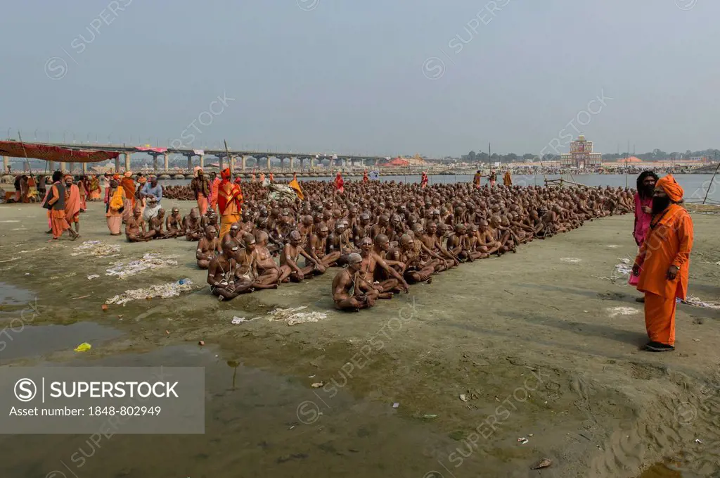 Sitting in silence as part of the initiation of new sadhus at the Sangam, the confluence of the rivers Ganges, Yamuna and Saraswati, during Kumbha Mel...