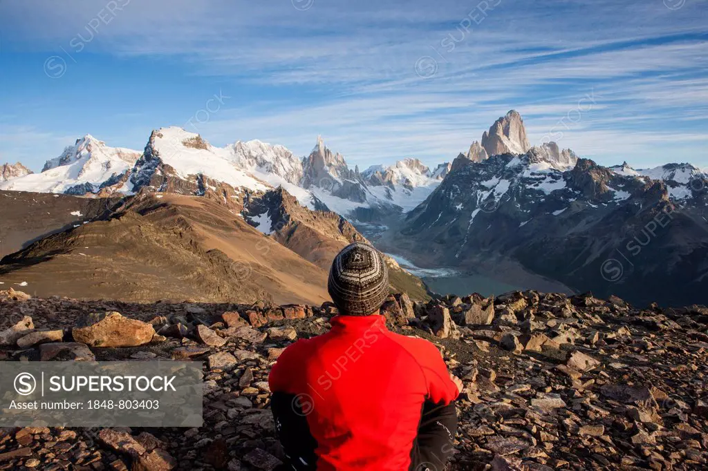 Hiker at the Loma del Pliegue Tumbado, views of Cerro Torre and the Fitz Roy massif
