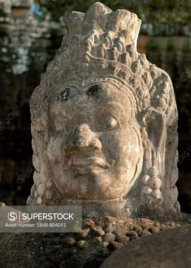 Detail of a figure from the right boundary of the access road to the south gate, Gopura, of Angkor Thom where stone figures representing demons or Asu...