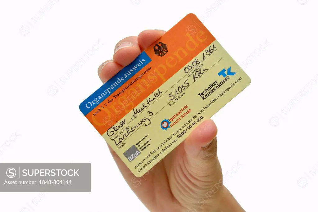 Hand holding a filled-out organ donor card, fictional data