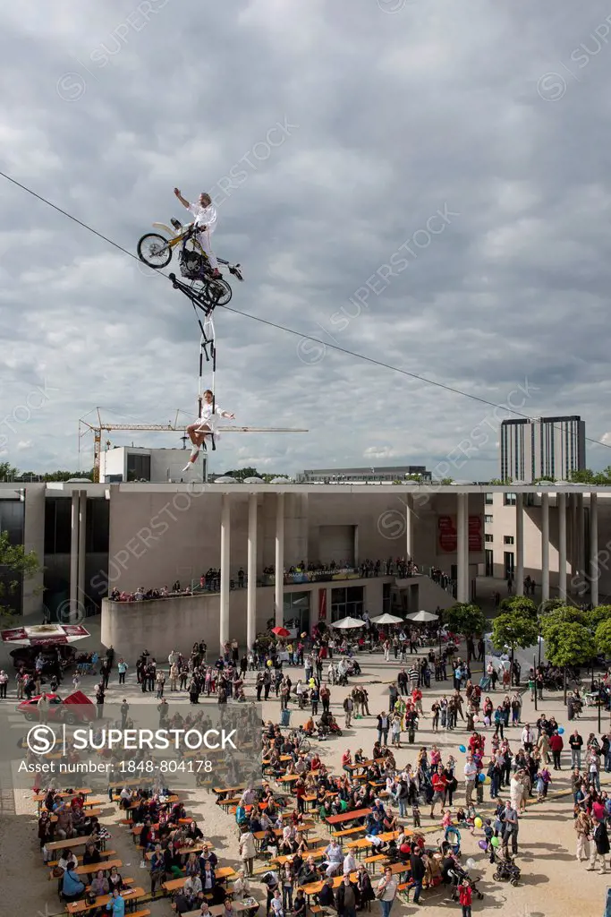 Museum Mile Festival, high-wire artist Falko Traber riding a motorbike on the tightrope, audience below, Bonn, North Rhine-Westphalia, Germany, Europe