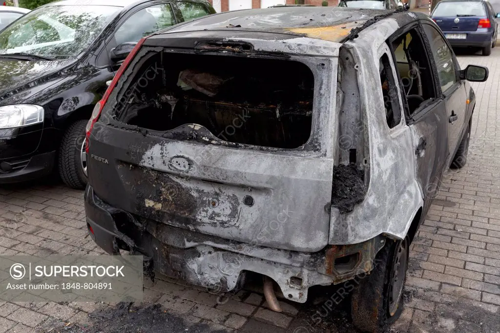 Burnt out Ford Fiesta in a car park, Düsseldorf, Rhineland, North Rhine-Westphalia, Germany