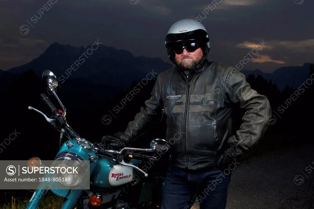 Motorcycle rider standing next to his motorbike, Werfen, Pongau, Salzburg state, Austria