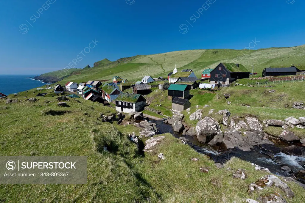 Village with houses mostly in the traditional Faroese style, wood on a stone base with a sod roof, Mykines, Mykines, Faroe Islands, Denmark