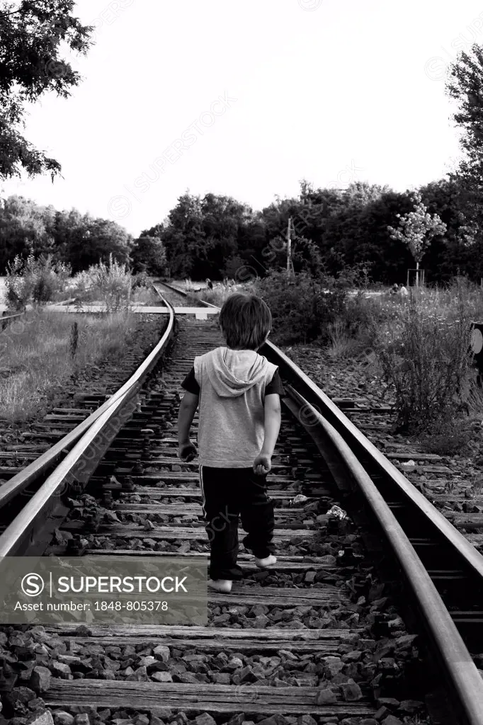 Little boy walking on rail tracks, Berlin, Berlin, Germany