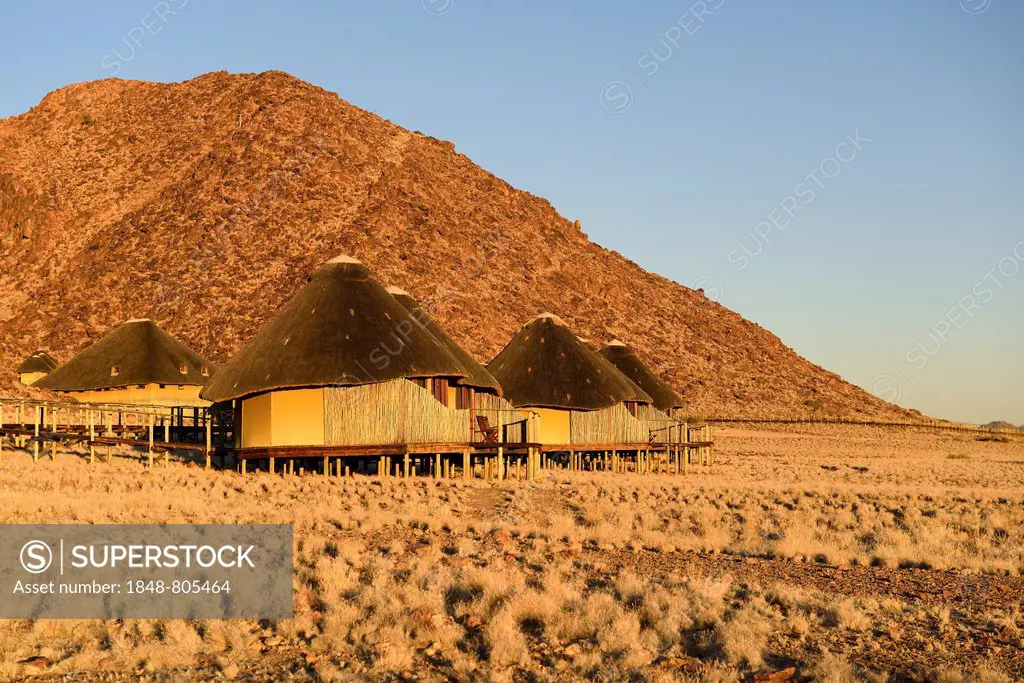 Huts or lodges of the Sossus Dune Lodge Hotel in the evening light, Sossusvlei, Namib Desert, Namib Naukluft Park, Namibia