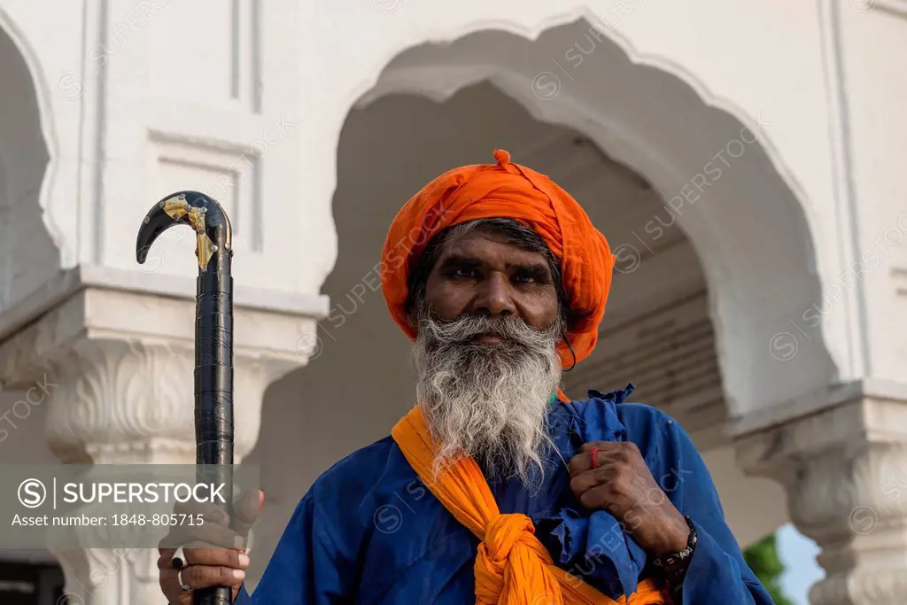 Portrait of a Nihang, a member of an armed Sikh order, wearing a traditional dress at the Harmandir Sahib or Golden Temple, a holy Sikh temple, Amrits...